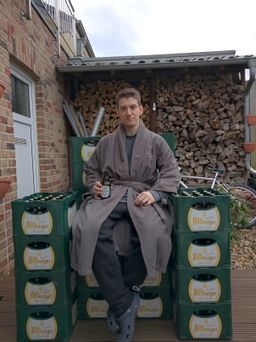 A picture of Leon Linhart sitting on an improvised throne built out of beer crates.